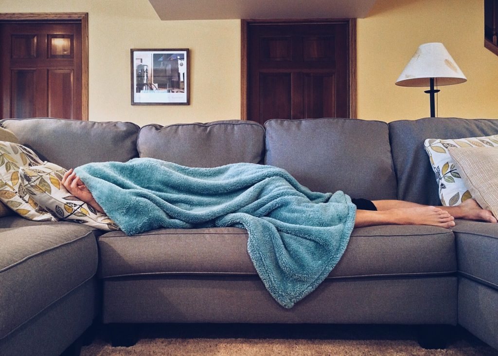 Person sleeping on a couch, Common Issues That Arise With Sleep Apnea Treatment