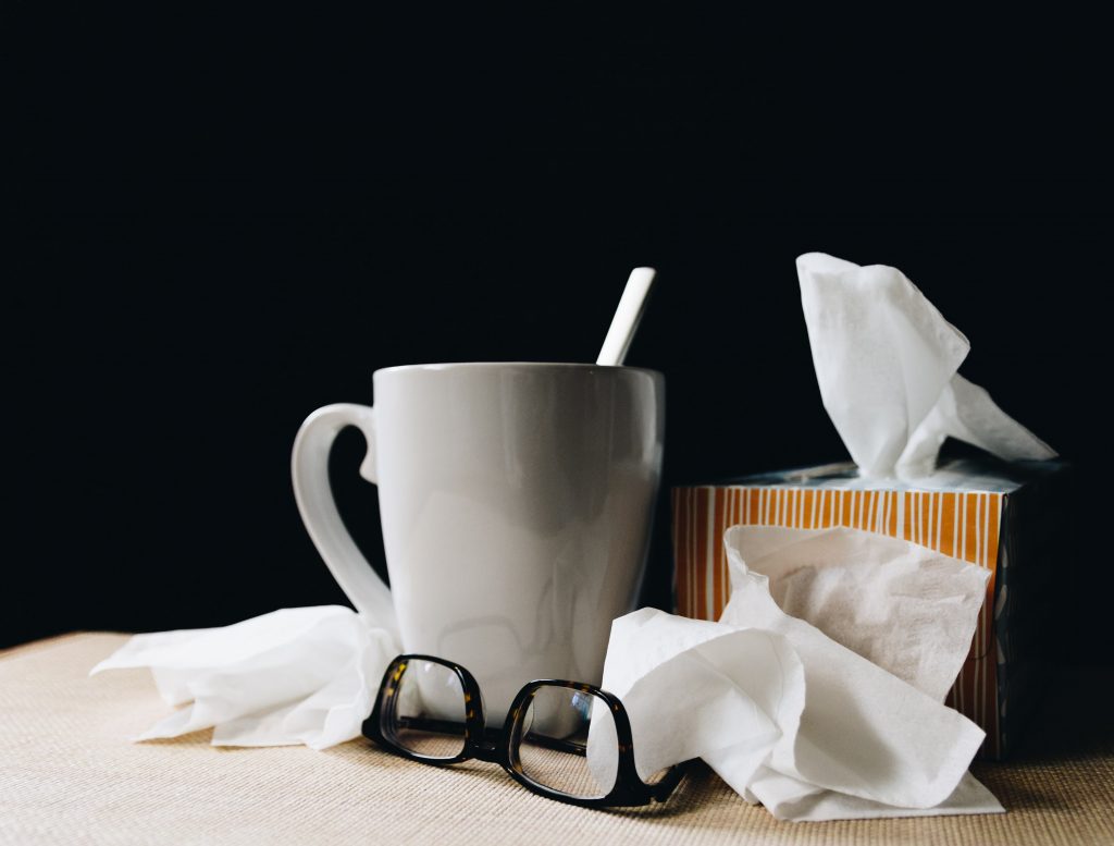How sleep impacts the immune system, coffee cup, glasses, and tissues on a table