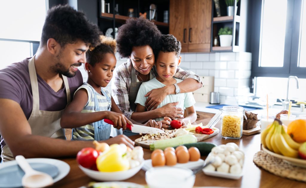 The Importance of Family Health, a family making food together and looking happy