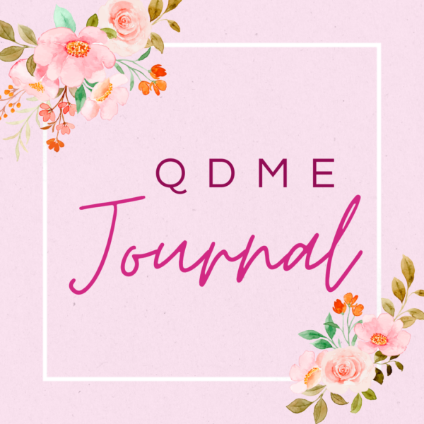 An image featuring QDME Journal set against a soft pink backdrop adorned with delicate flowers