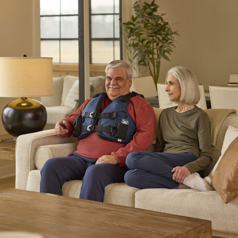 AffloVest man and woman on couch